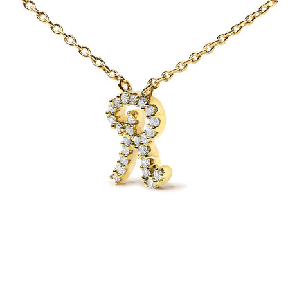 Close-up front angle of a yellow metal necklace with a pendant shaped like the letter R, adorned with small white gemstones in a micro-pave setting.