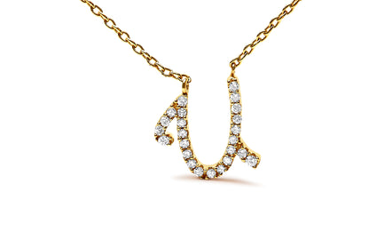 Close-up front angle of a yellow metal necklace with a pendant shaped like a stylized letter 'U,' adorned with round white gemstones in micro-pave setting.