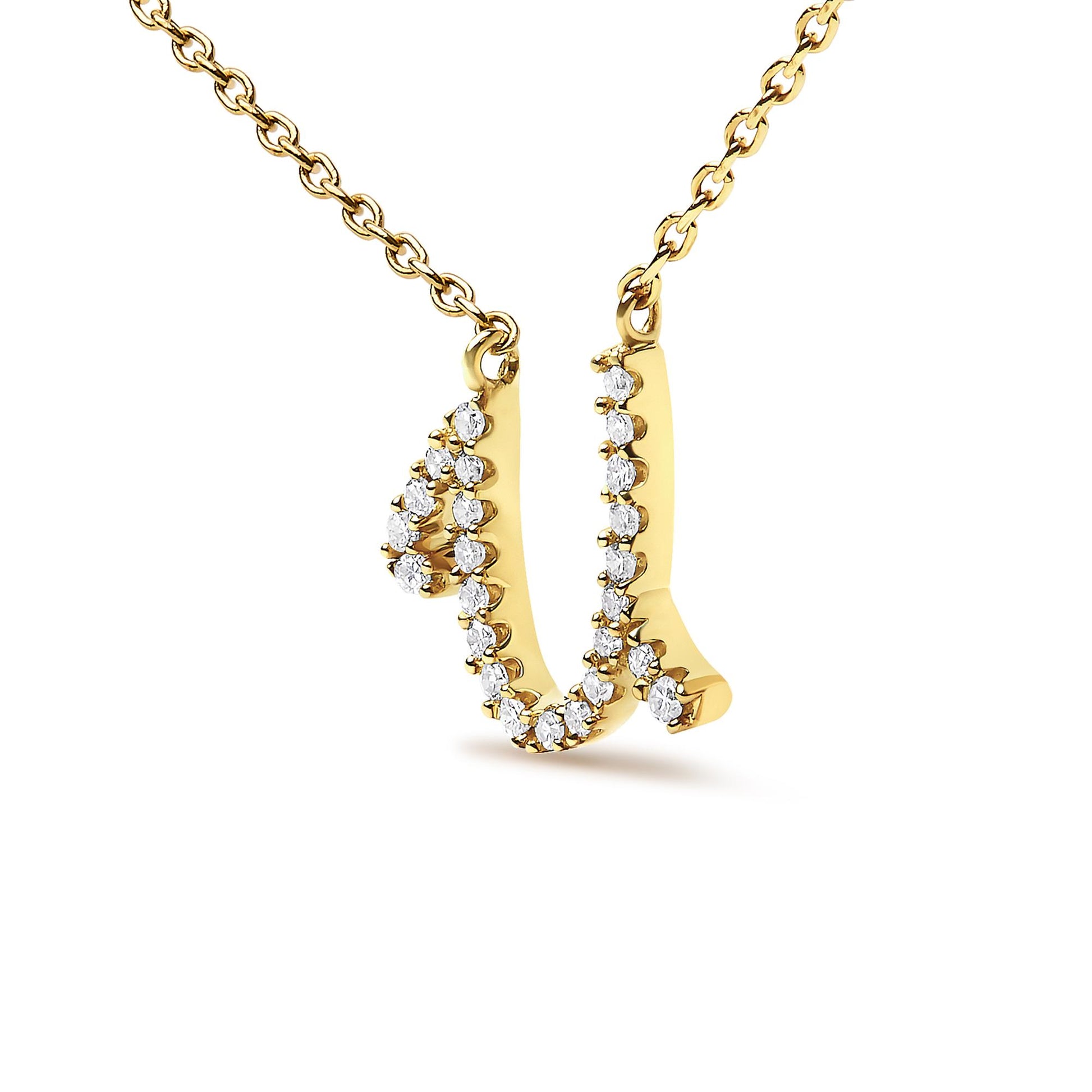 Close-up front angle of a yellow metal necklace pendant shaped like the letter 'U' adorned with round white gemstones in a micro-pave setting, shown on a white background.