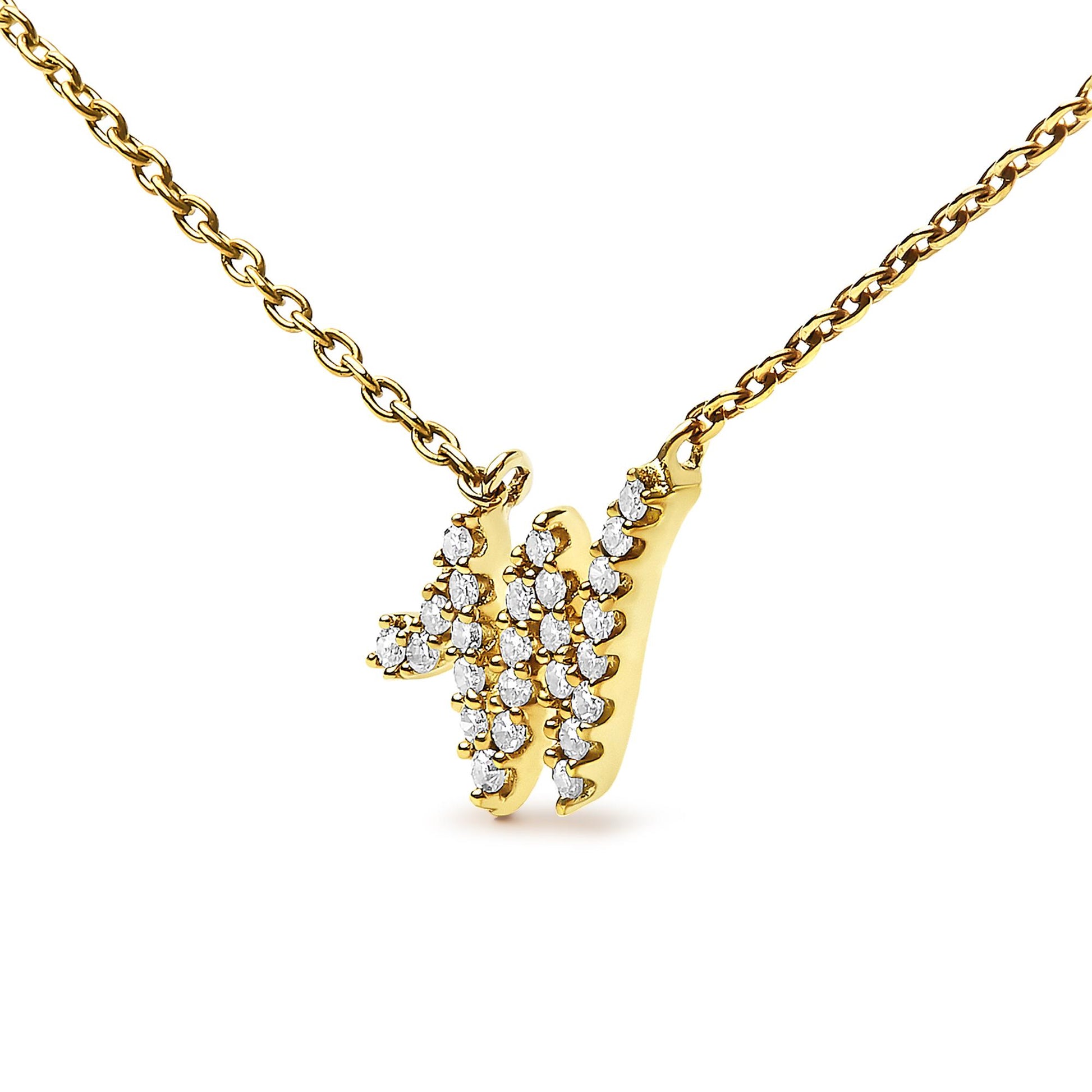 Close-up front angle of a yellow metal necklace with a pendant shaped like the letter 'W,' set with multiple small round white gemstones in a micro-pave setting.