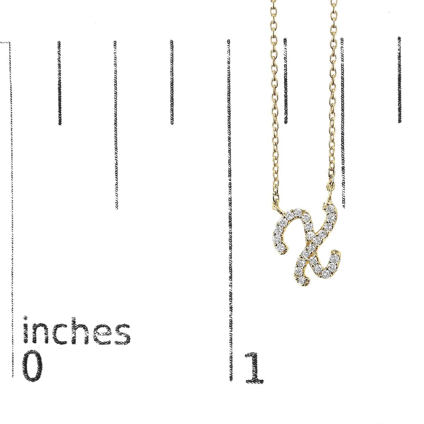 Close-up front view of a yellow metal necklace pendant in the shape of the letter X, adorned with white round gemstones in a micro-pave setting, shown on a scale.
