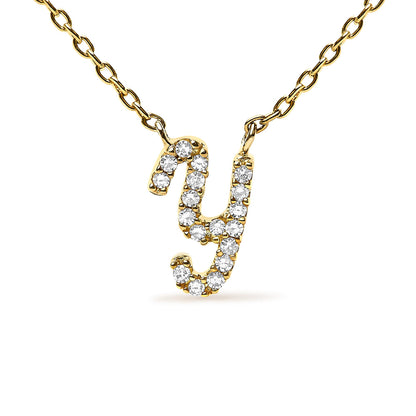 Close-up front view of a yellow metal necklace with a lowercase letter 'y' pendant set with round white gemstones in a micro-pave setting.