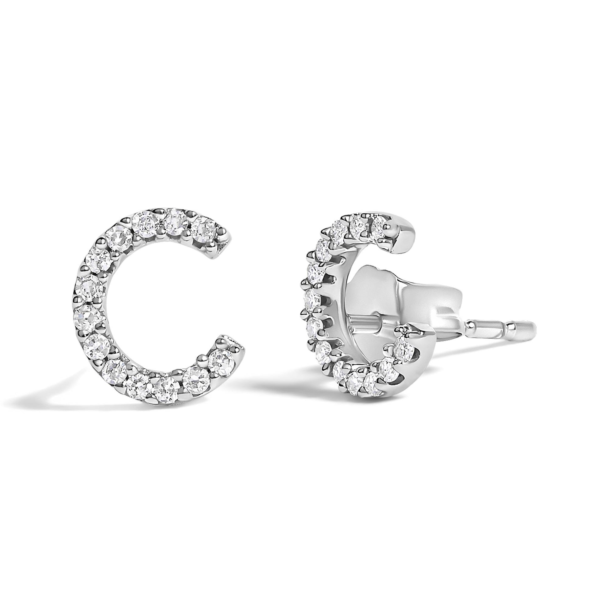 Pair of white metal crescent-shaped earrings with round white gemstones in a micro-pave setting, shown from a front and angled side view on a white background.