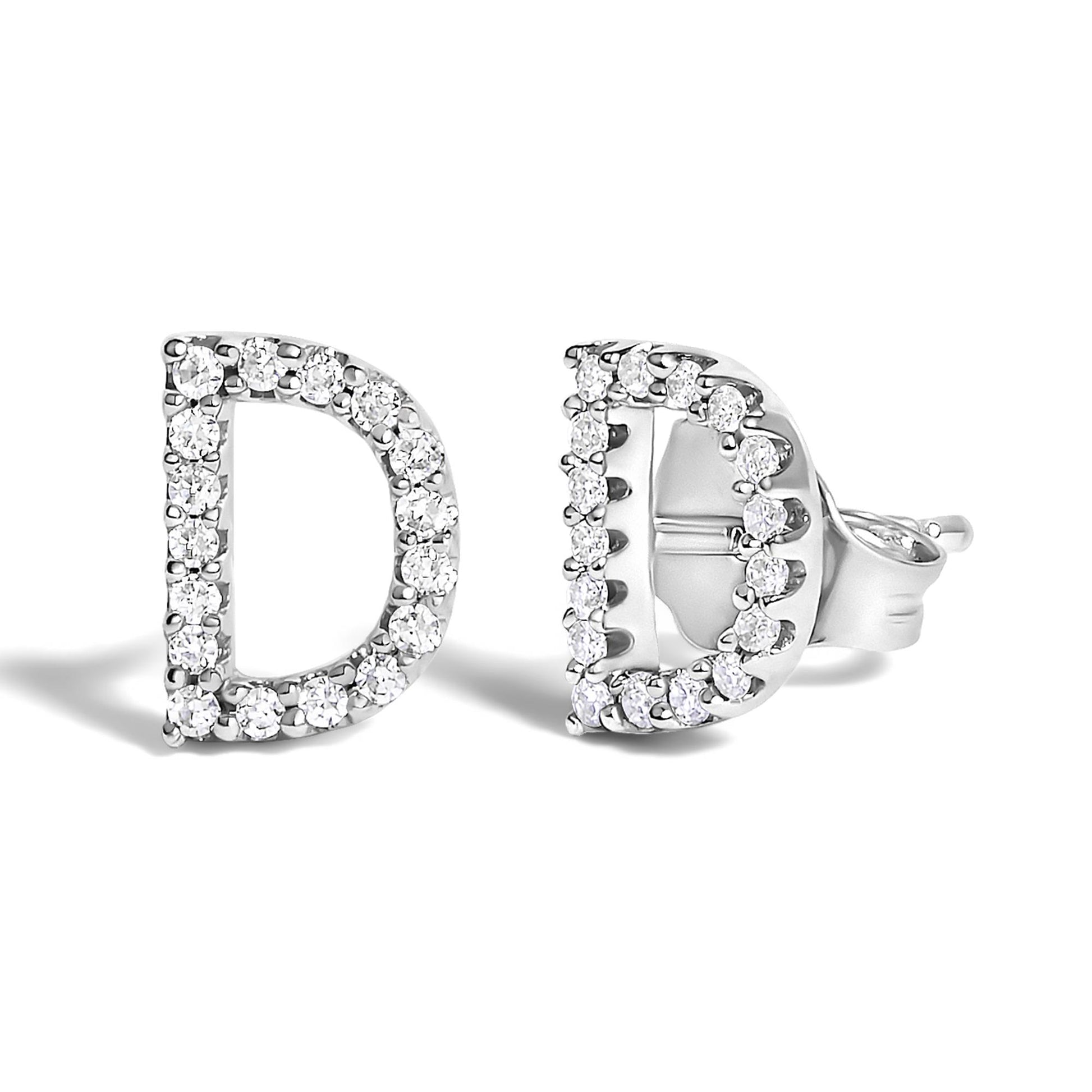 Close-up front and side angle of a pair of white metal stud earrings shaped like the letter D, adorned with round white gemstones in a micro-pave setting.