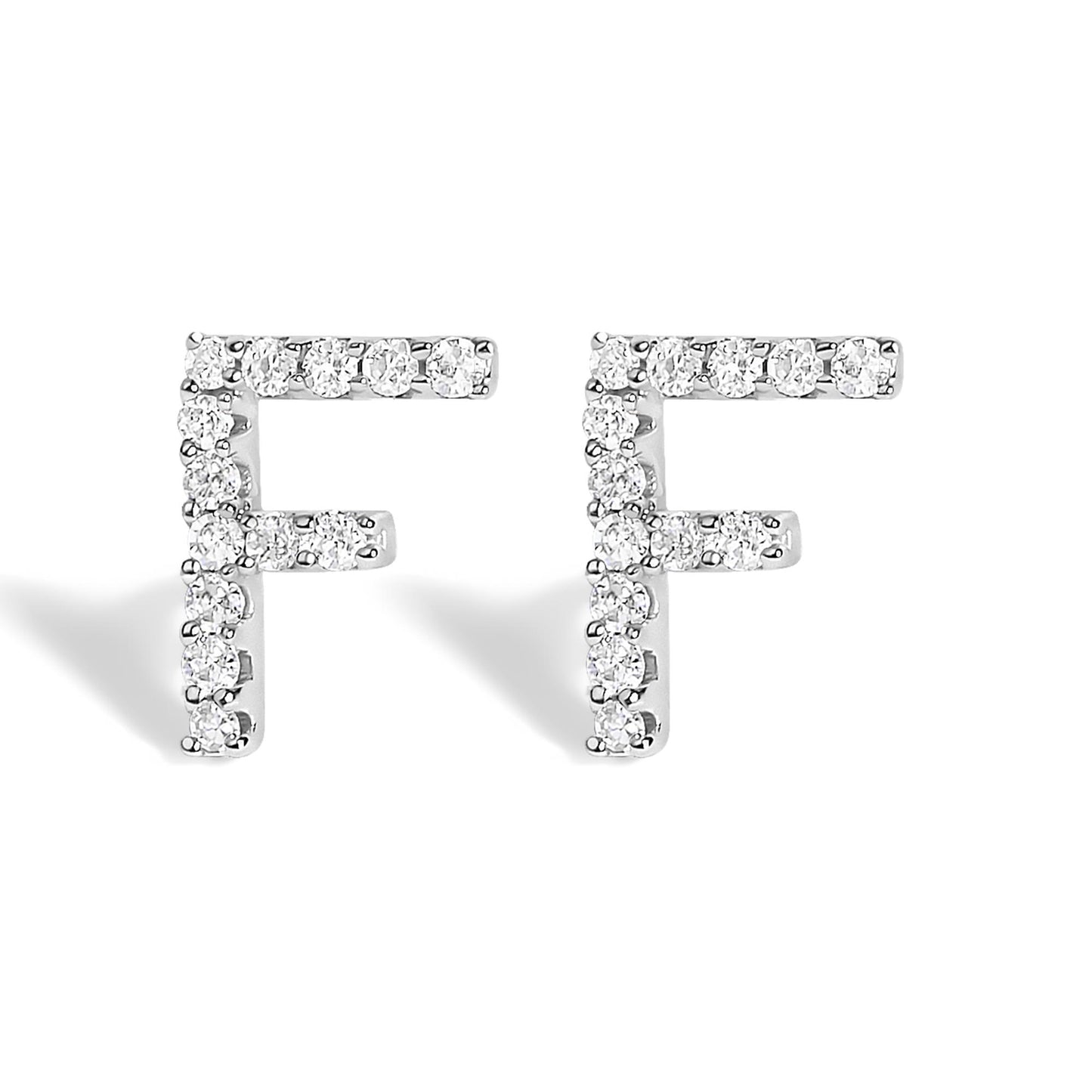 Front-facing close-up of a pair of white metal stud earrings shaped as the letter F, each adorned with round white gemstones in a micro-pave setting.