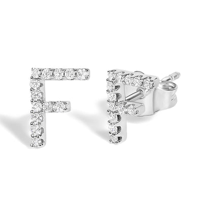 Close-up front and side angle of a pair of white metal stud earrings shaped like the letter F, encrusted with small round white gemstones in a micro-pave setting.