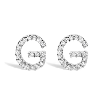 Front view of a pair of white metal earrings shaped like the letter G, each outlined with round white gemstones in a micro-pave setting.