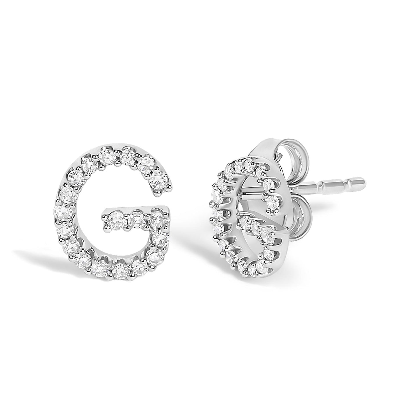 Close-up front and side view of white metal earrings shaped like the letter G, paved with small round white gemstones.