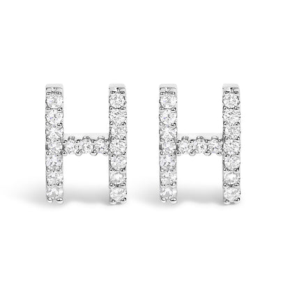Front-facing view of white metal earrings shaped like the letter H, adorned with multiple round white gemstones in a micro-pave setting.