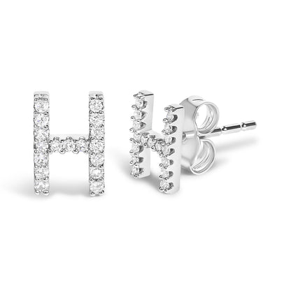 Close-up front and side view of white metal stud earrings shaped like the letter H, each adorned with round white gemstones in a micro-pave setting.