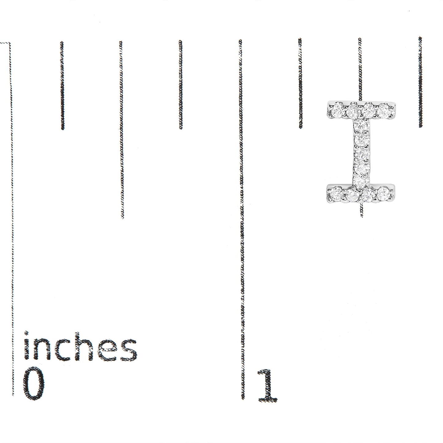 White metal earring shaped like the letter 'I' with small white gemstones in a micro-pave setting shown on a measurement scale from 0 to 1 inch, front view.