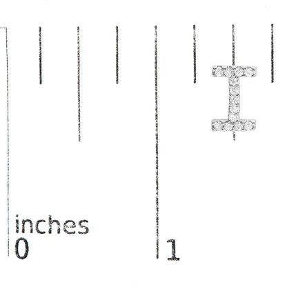 White metal earring shaped like the letter 'I' with small white gemstones in a micro-pave setting shown on a measurement scale from 0 to 1 inch, front view.