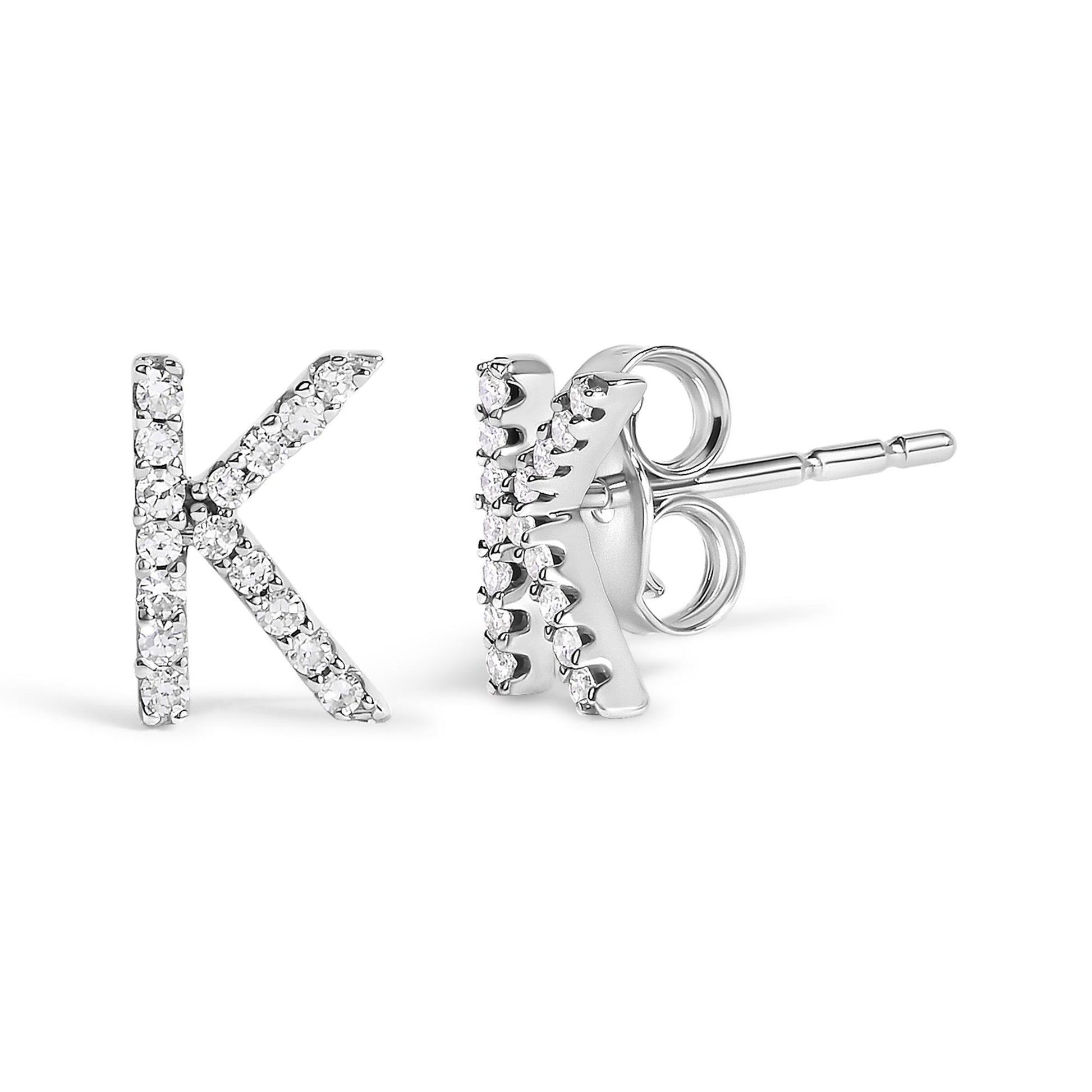 Close-up front and side view of white metal stud earrings shaped like the letter K, embellished with small round white gemstones in a micro-pave setting.
