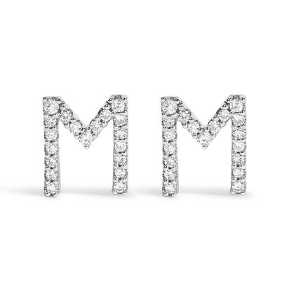 Front view of a pair of white metal earrings shaped like the letter M, each adorned with round white gemstones in a micro-pave setting.
