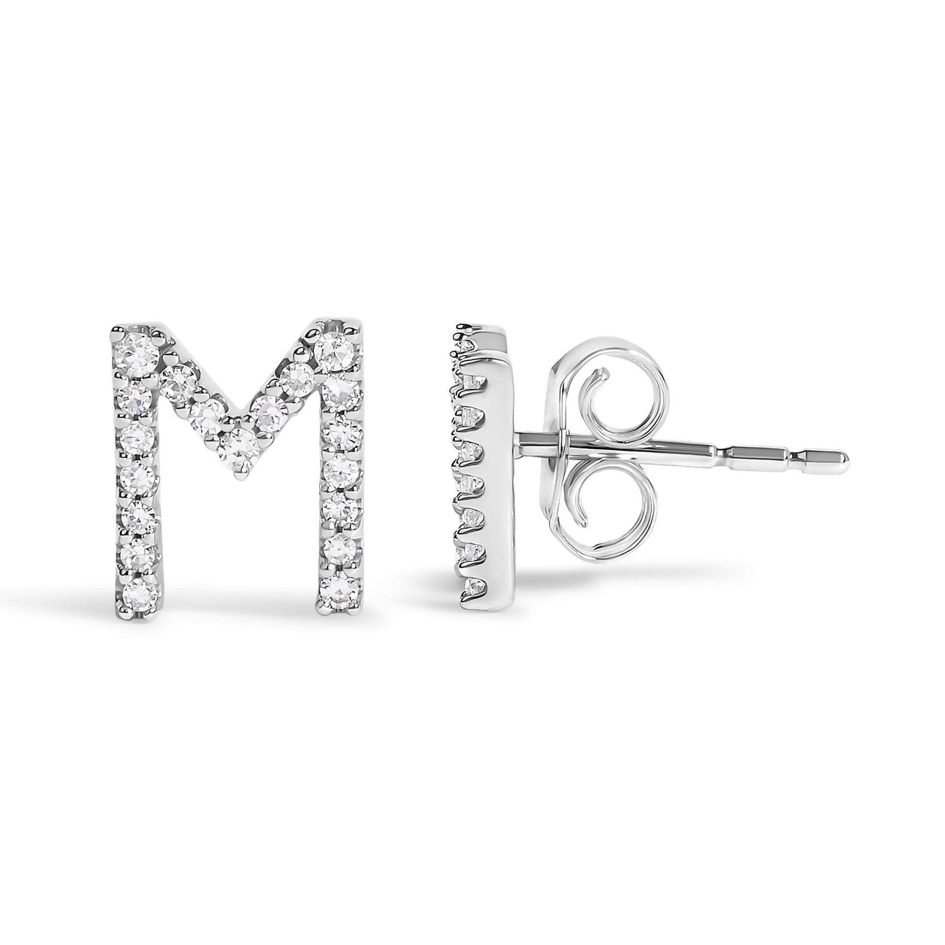 Close-up front and side view of a white metal stud earring shaped like the letter M, adorned with multiple round white gemstones in a micro-pave setting.