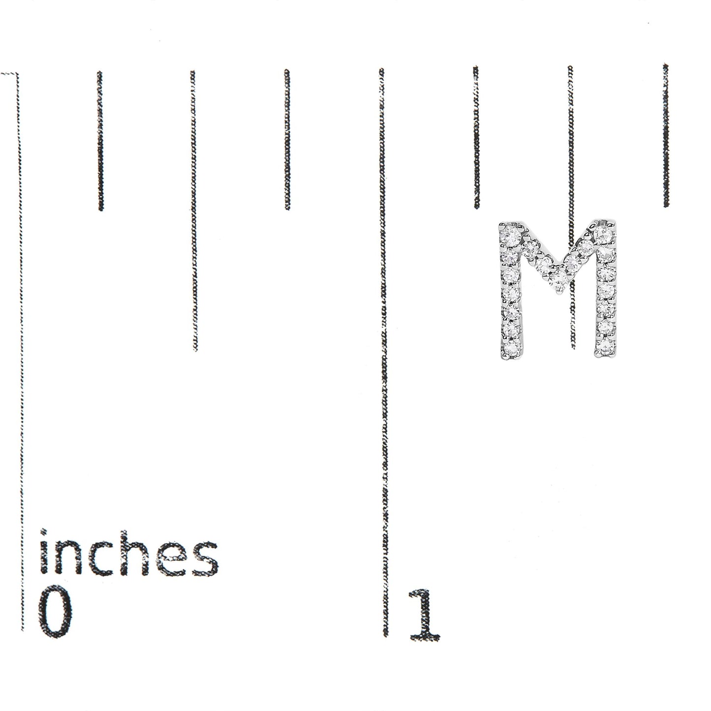 White metal earring shaped like the letter M, featuring round white gemstones in a micro-pave setting, shown on a scale with inch markings from 0 to 1, front view.