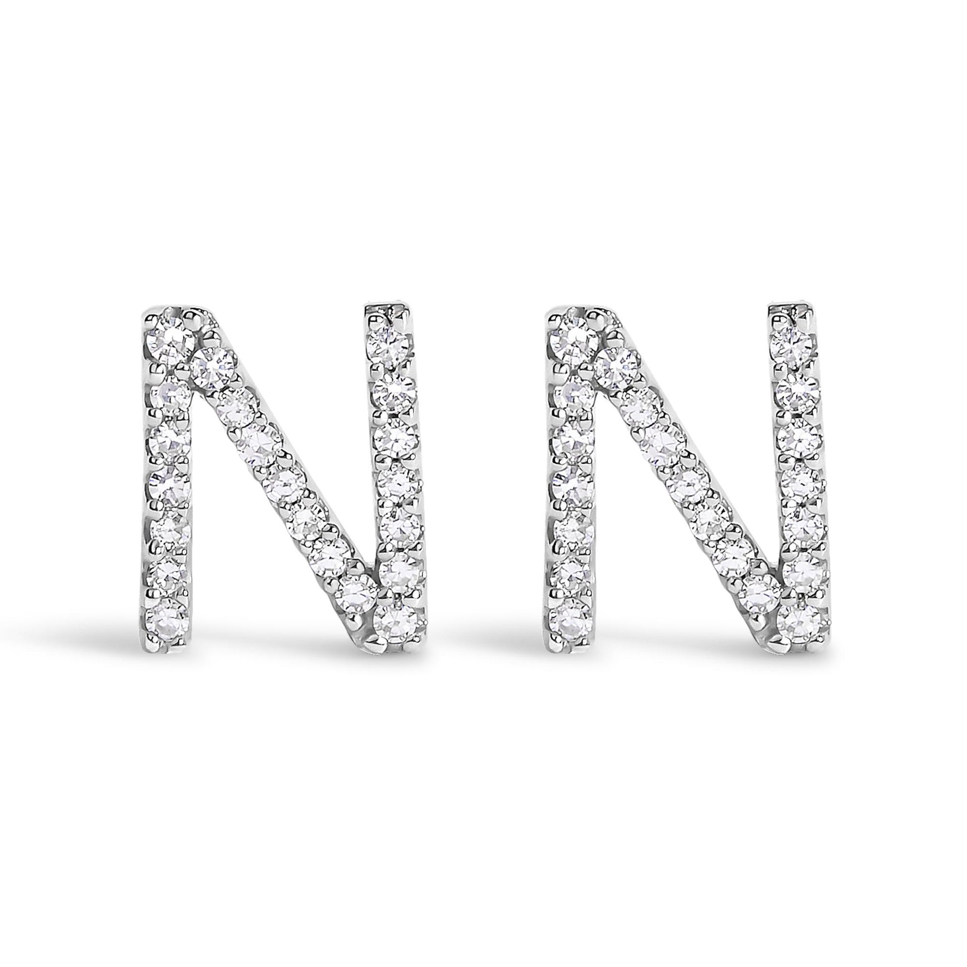 Front view of a pair of white metal earrings shaped like the letter N, each adorned with round white gemstones in a micro-pave setting.