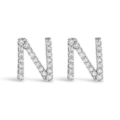 Front view of a pair of white metal earrings shaped like the letter N, each adorned with round white gemstones in a micro-pave setting.
