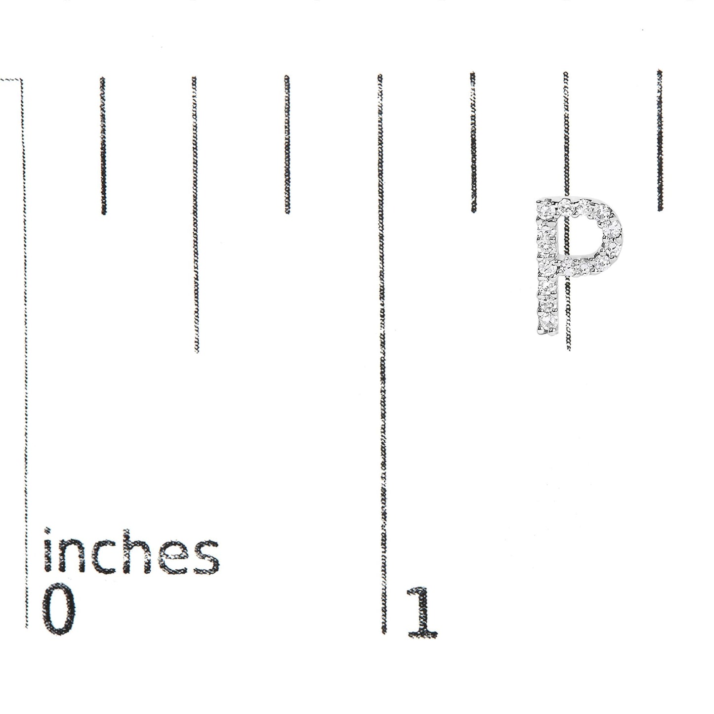 Close-up front angle of a white metal earring shaped like the letter P, set with round white gemstones, shown on a scale marked in inches.