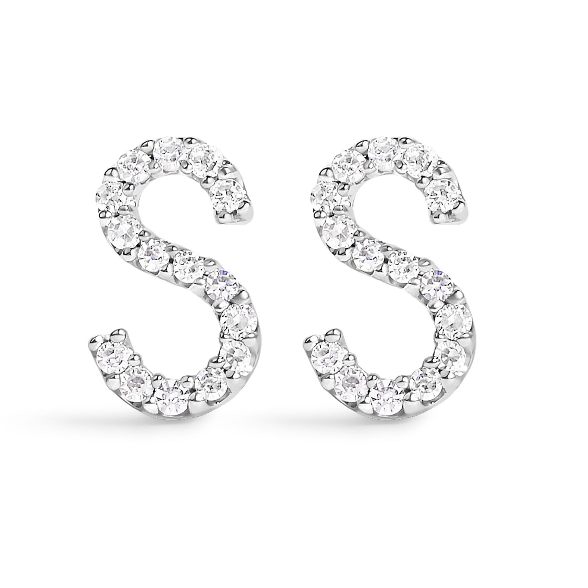 Pair of white metal earrings shaped like the letter S, set with round white gemstones in a micro-pave setting, shown from the front angle on a white background.