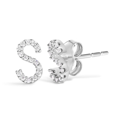 Close-up front and side view of white metal stud earrings shaped like the letter S, set with small round white gemstones in a micro-pave setting.