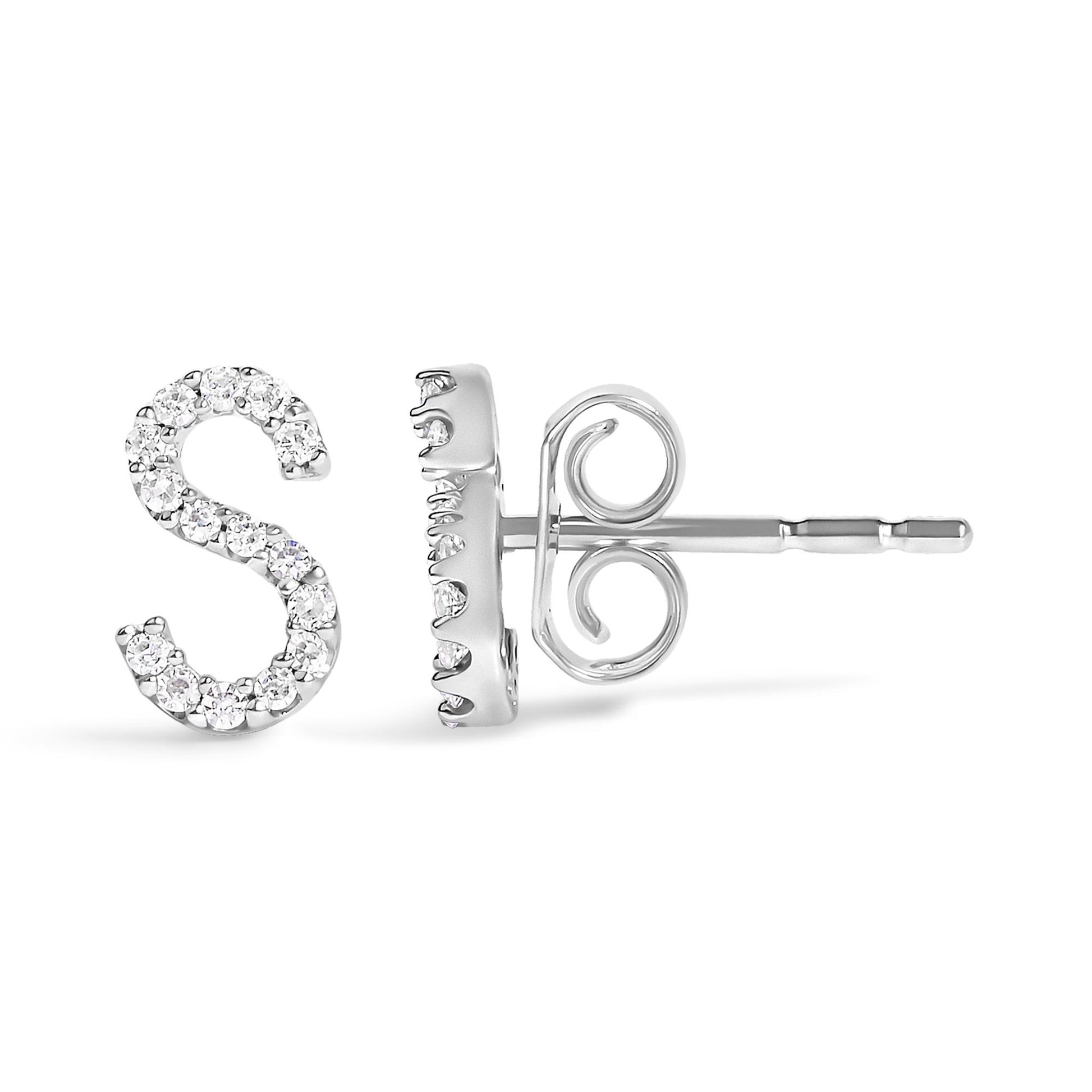 Close-up side and front angle view of white metal stud earrings in the shape of the letter S, adorned with small round white gemstones in a micro-pave setting, shown on a white background.
