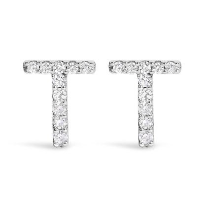 Front-facing close-up of a pair of white metal T-shaped earrings with round white gemstones in a micro-pave setting.