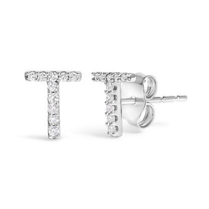 Close-up front and side view of white metal T-shaped earrings with round white gemstones in micro-pave setting.