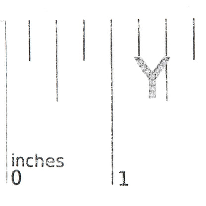 Close-up front angle of a white metal letter Y-shaped earring with round white gemstones in micro-pave setting, shown on a scale.