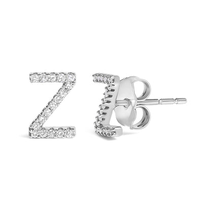 Close-up front and side view of white metal stud earrings shaped like the letter Z, featuring round white gemstones in a micro-pave setting.