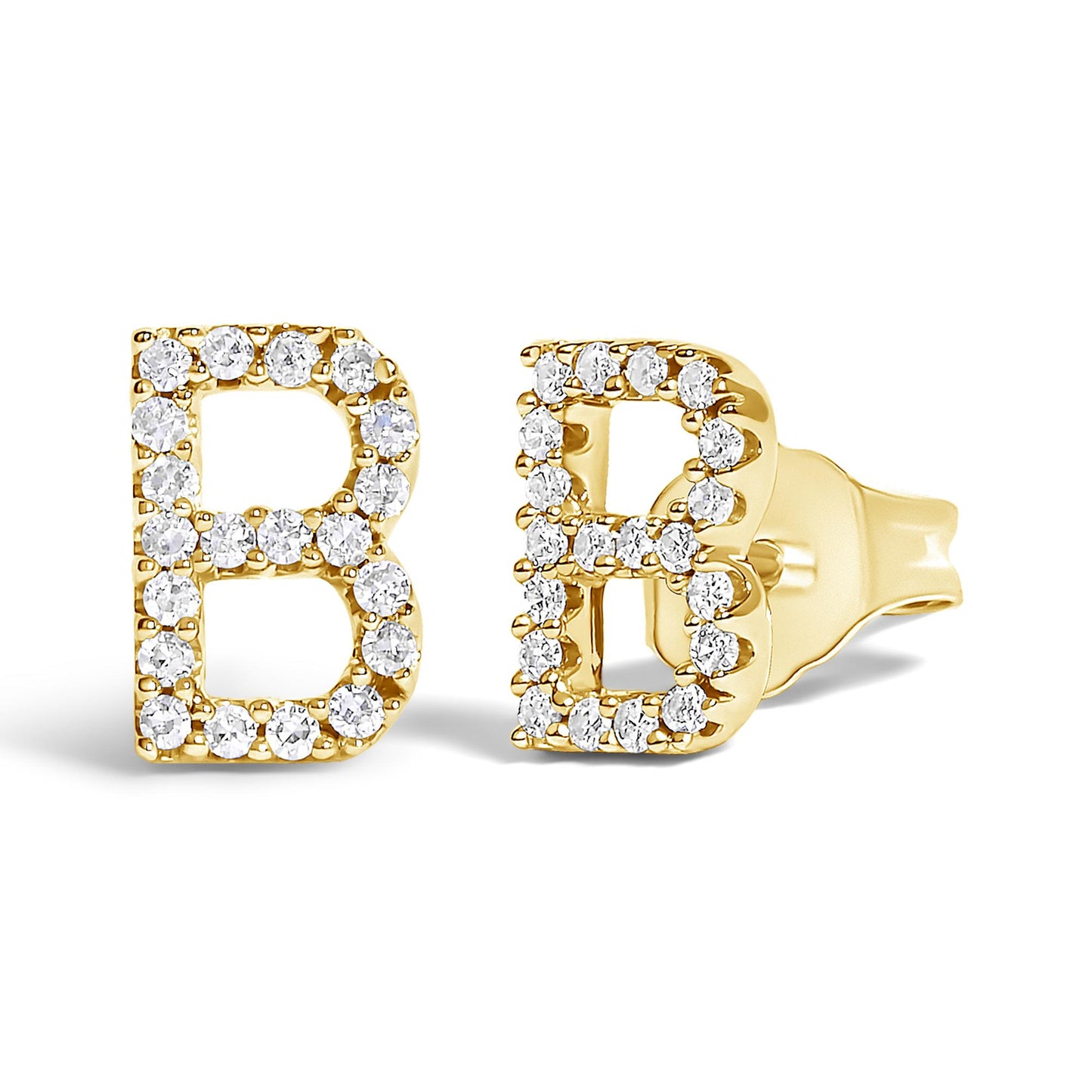 Close-up angled view of a pair of yellow metal earrings shaped as the letter B, each outlined with round white gemstones in a micro-pave setting.