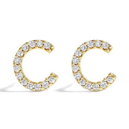 Pair of yellow metal earrings shaped like open circles, adorned with white round gemstones in a micro-pave setting, shown in a front-facing angle on a white background.