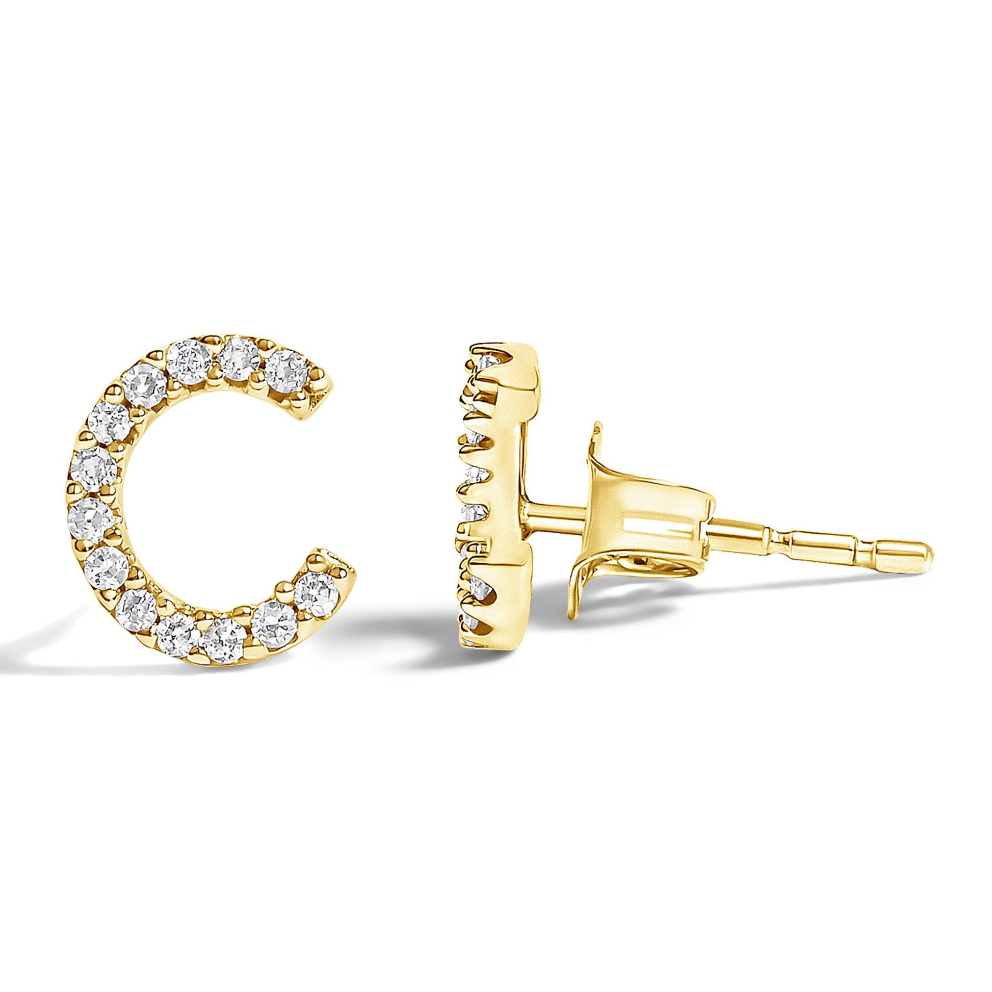 Close-up image of yellow metal earrings shaped like the letter C, adorned with round white gemstones in a micro-pave setting, shown from front and side angles on a white background.
