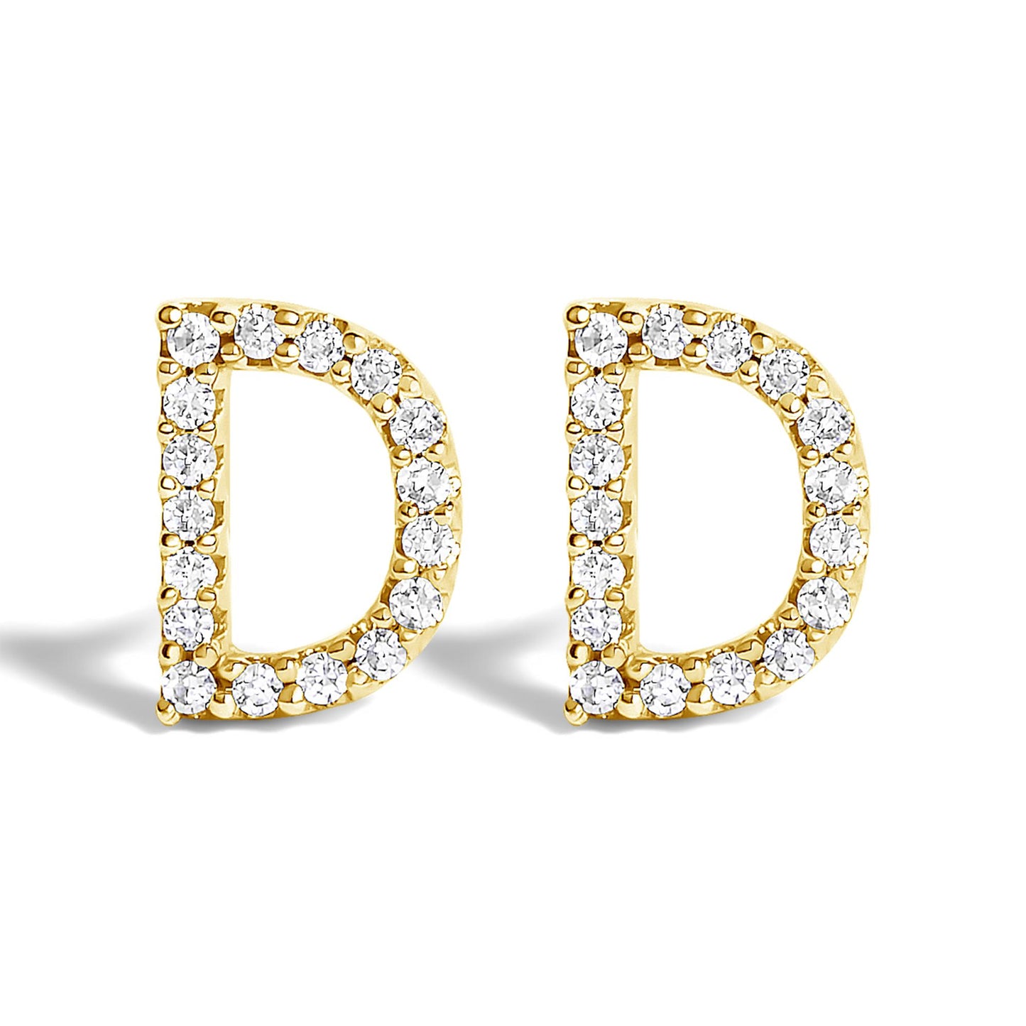 Front-facing close-up of a pair of yellow metal earrings shaped like the letter D, each outlined with small white round gemstones in a micro-pave setting.