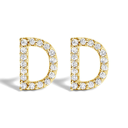 Front-facing close-up of a pair of yellow metal earrings shaped like the letter D, each outlined with small white round gemstones in a micro-pave setting.