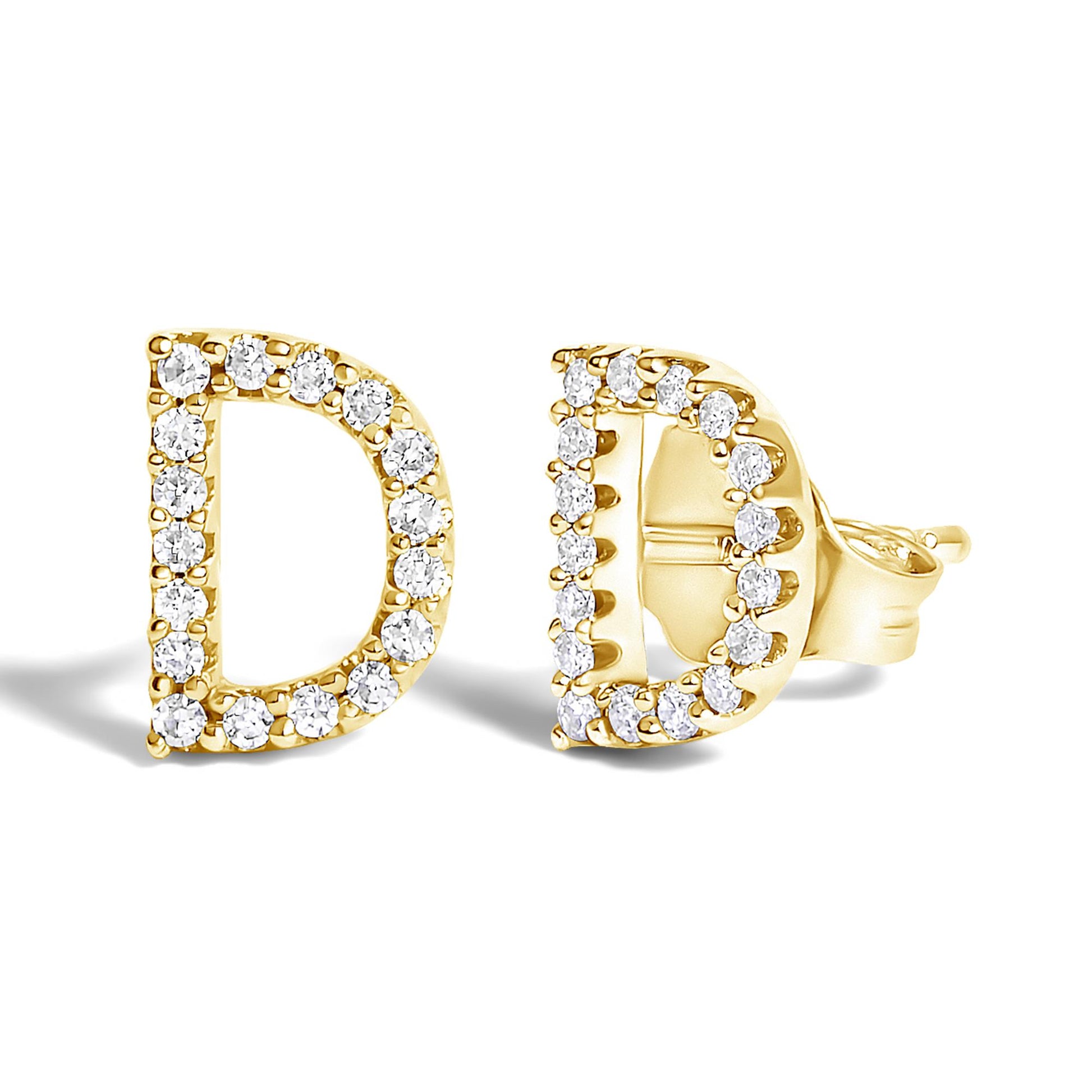 Pair of yellow metal earrings shaped like the letter D, outlined with small round white gemstones, shown from a front and side angle on a white background.