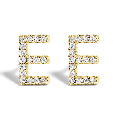 Front angle shot of yellow metal earrings shaped like the letter E, each set with multiple white round gemstones in a micro-pave setting.