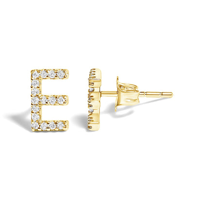 Close-up front and side view of yellow metal stud earrings shaped like the letter E, adorned with small white gemstones in a micro-pave setting.