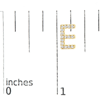 Close-up front view of a yellow metal earring shaped like the letter E, adorned with round white gemstones in a micro-pave setting, shown on a measurement scale.