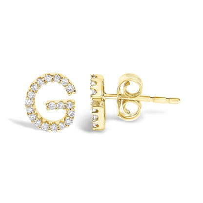Close-up front and side view of a yellow metal stud earring shaped like the letter G, adorned with white round micro-pave gemstones.