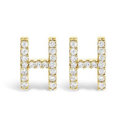 Front view of a pair of yellow metal earrings shaped like the letter H, each adorned with round white gemstones in a micro-pave setting.