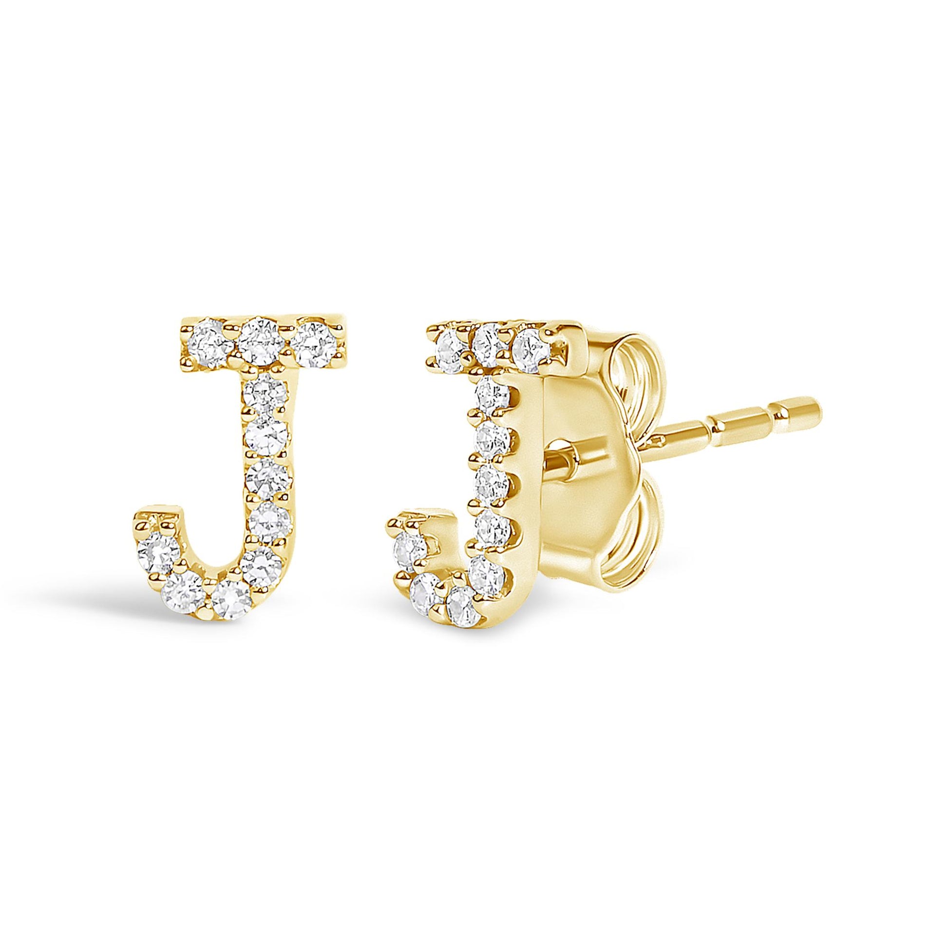 Pair of yellow metal earrings shaped as the letter J adorned with round white gemstones in a micro-pave setting, shown at a slight angled front and side view on a white background.