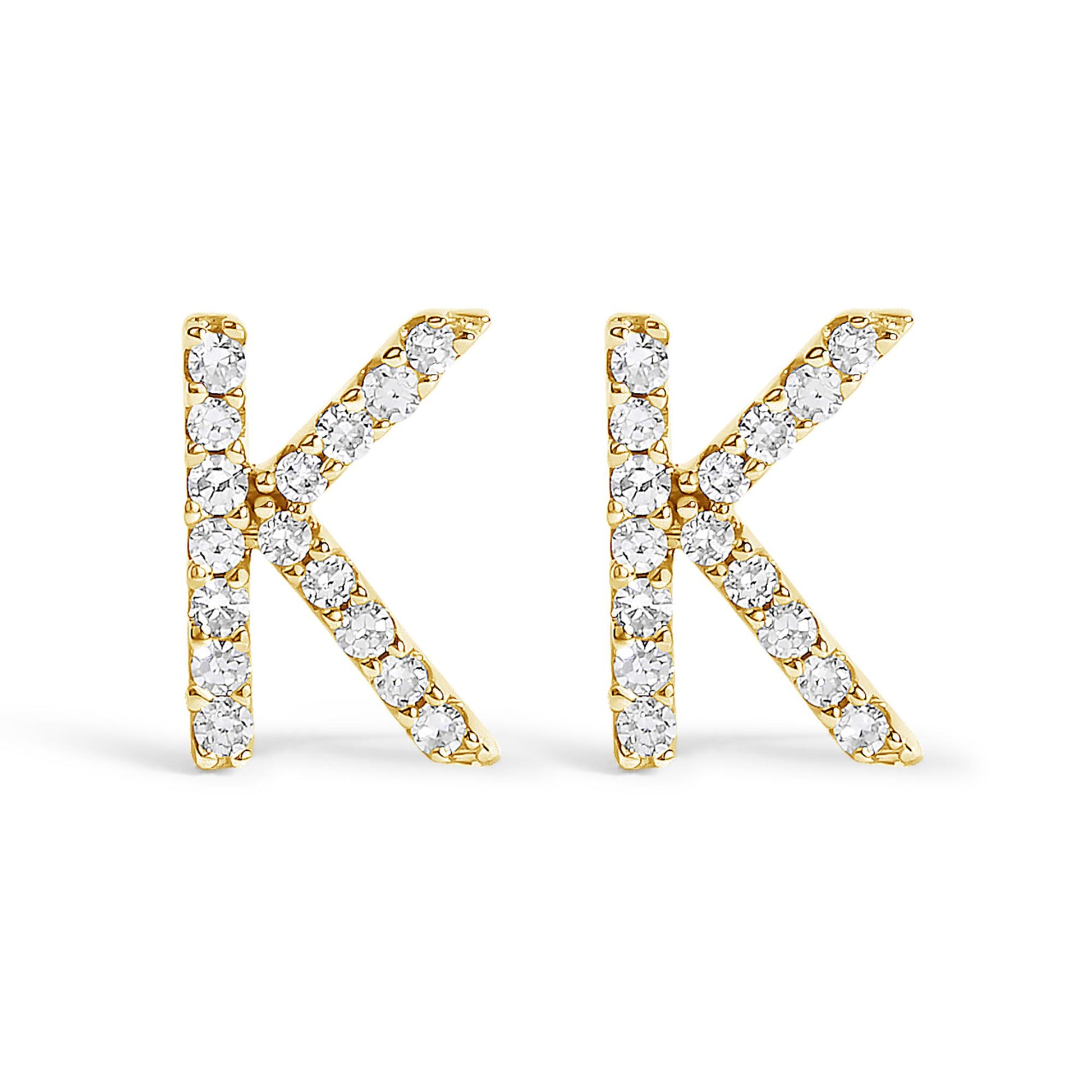 Pair of yellow metal stud earrings shaped like the letter K, each adorned with round white gemstones, shown from the front on a white background.