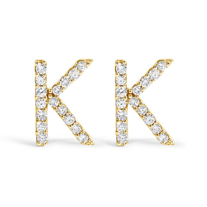 Pair of yellow metal stud earrings shaped like the letter K, each adorned with round white gemstones, shown from the front on a white background.