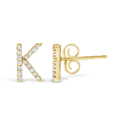 Close-up image of a yellow metal stud earring shaped like the letter K, adorned with small white gemstones in a micro-pave setting, shown from the front and side angles.