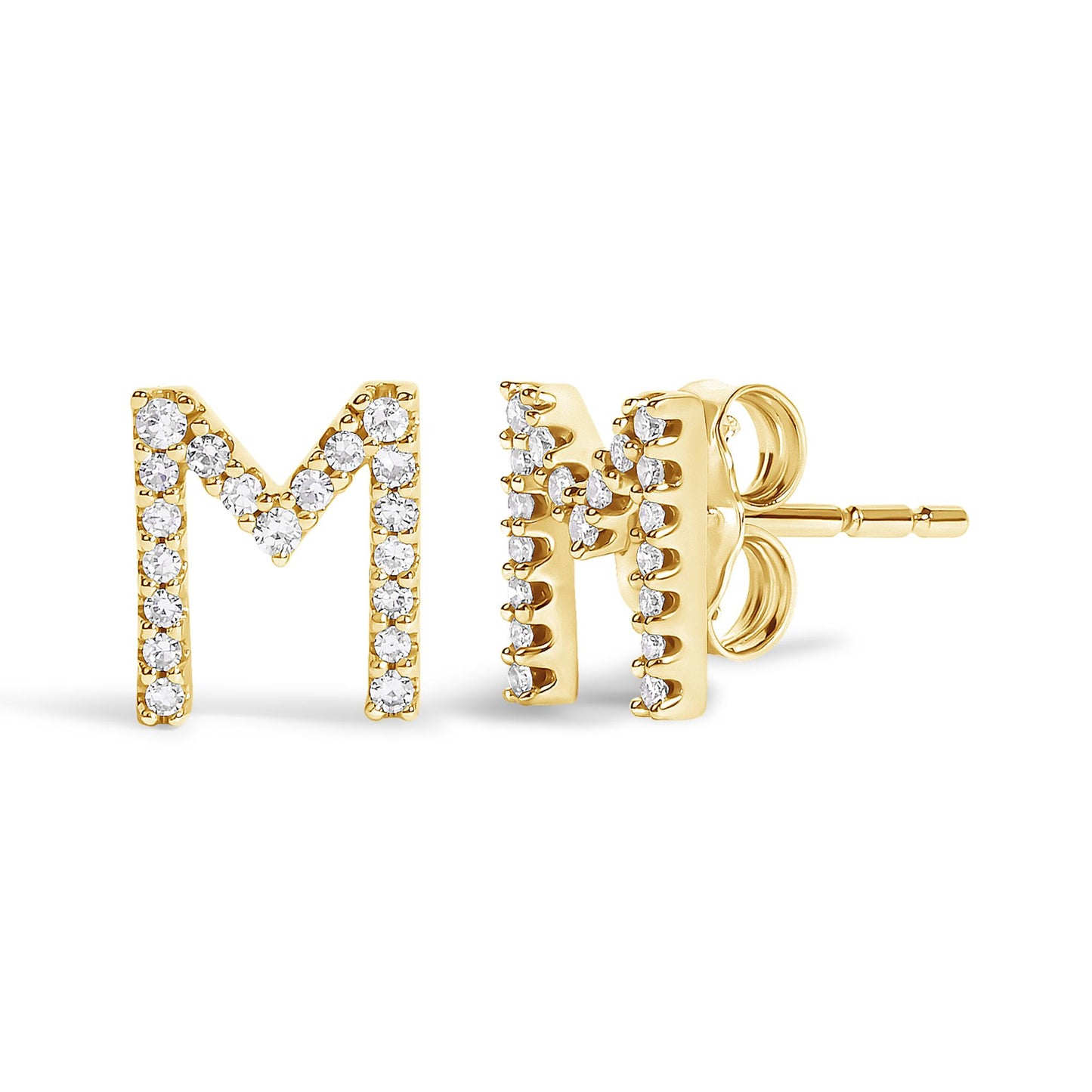 Close-up front and side view of yellow metal stud earrings shaped like the letter M, adorned with round white gemstones in a micro-pave setting.