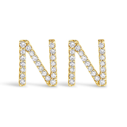 Pair of yellow metal earrings shaped as the letter N, adorned with round white gemstones in a micro-pave setting, shown at a front angle on a white background.
