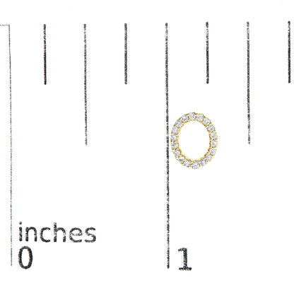 Close-up of a yellow metal oval-shaped earring with round white gemstones in a micro-pave setting, shown on a scale.