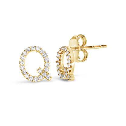 Close-up front and side view of yellow metal stud earrings shaped like the letter Q, set with round white gemstones in a micro-pave setting, shown on a white background.