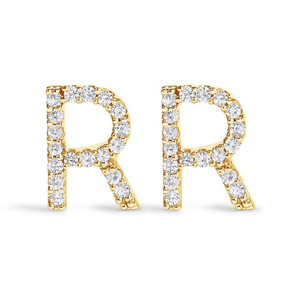 Front-facing close-up of a pair of yellow metal earrings shaped as the letter 'R,' each adorned with white round gemstones in a micro-pave setting.